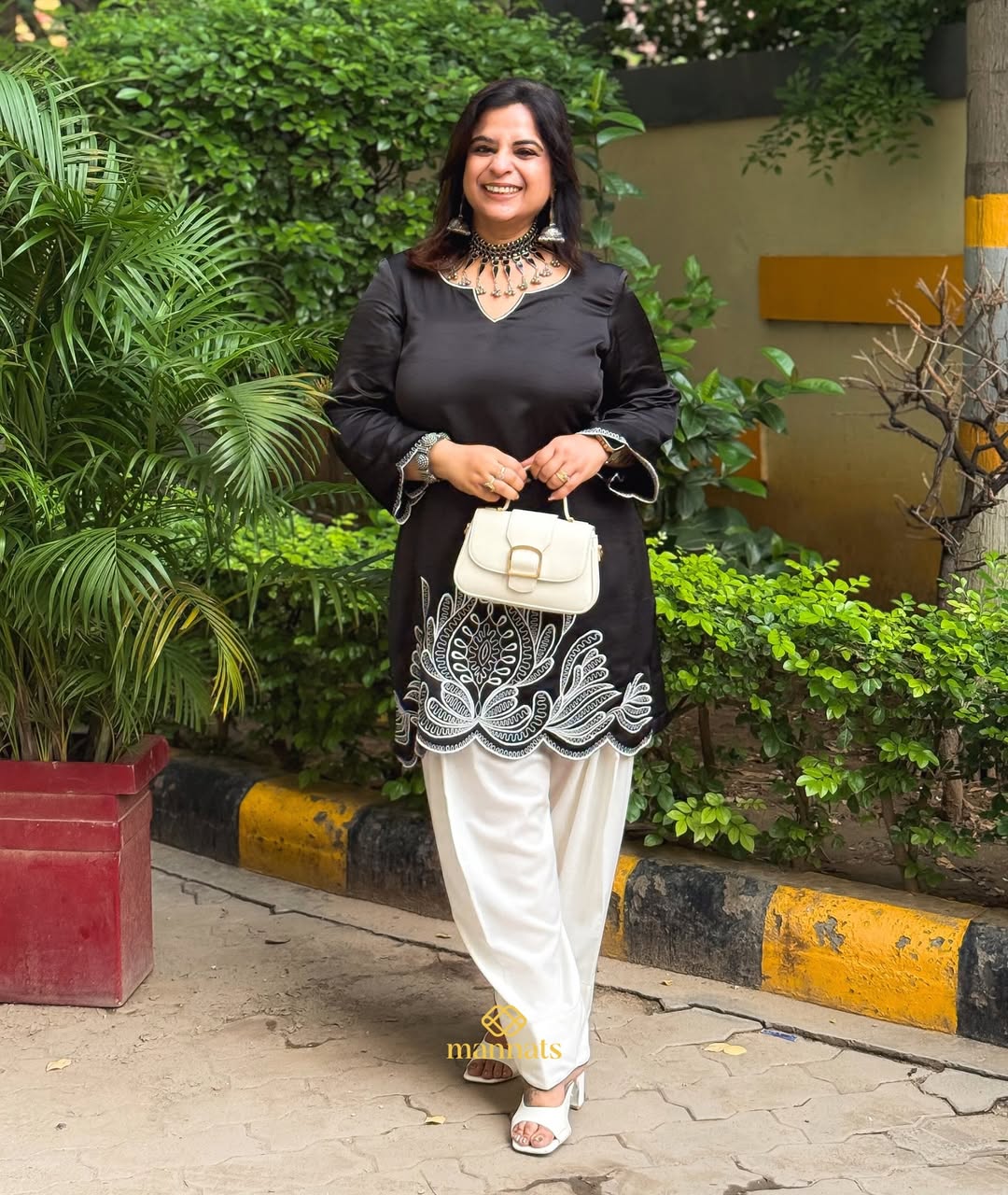 Black cotton silk kurta adorned with intricate embroidery, paired with a classic farshi salwar a